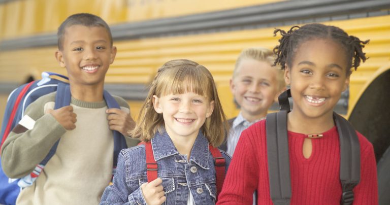 kids in front of bus.