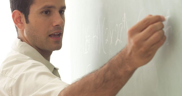 Teacher at chalkboard.