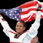Paige McPherson of the U.S. celebrates with a national flag after winning her women’s -67kg bronze medal taekwondo match against Slovenia’s Franka Anic at the London Olympic Games at the ExCeL venue