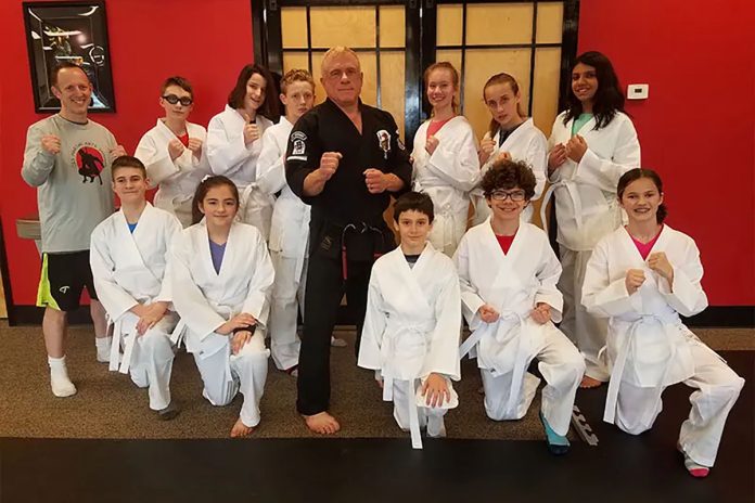 David Coppock welcomes a fresh group of new white belts into his school.