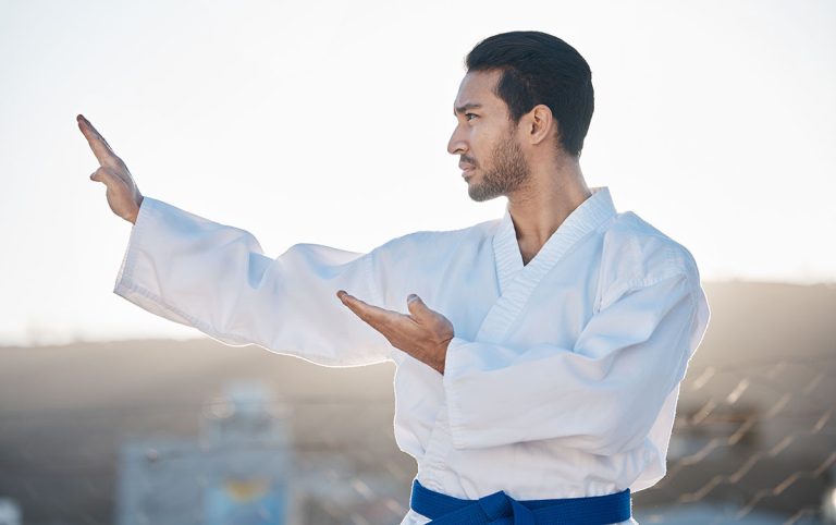 Martial arts man in knife hand pose.