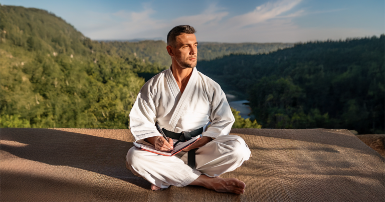 A martial artist strategizing with a notebook.