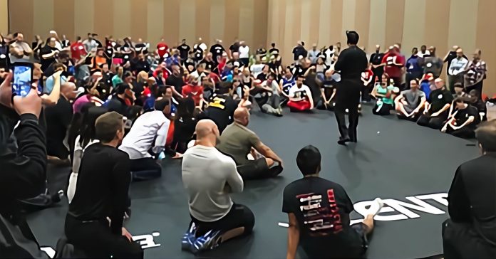 Tom Patire speaking in a room full of people.