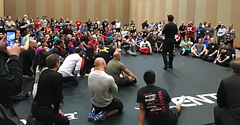 Tom Patire speaking in a room full of people.